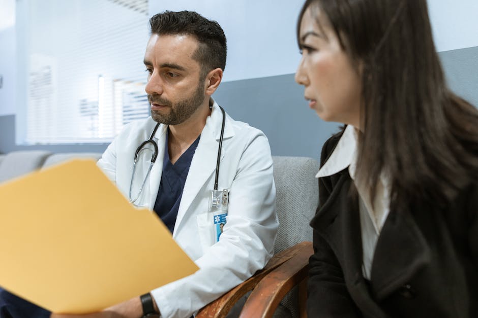 Doctor in a white coat talking with a woman holding a folder