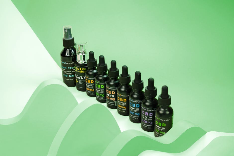 Row of dark dropper bottles on a green background